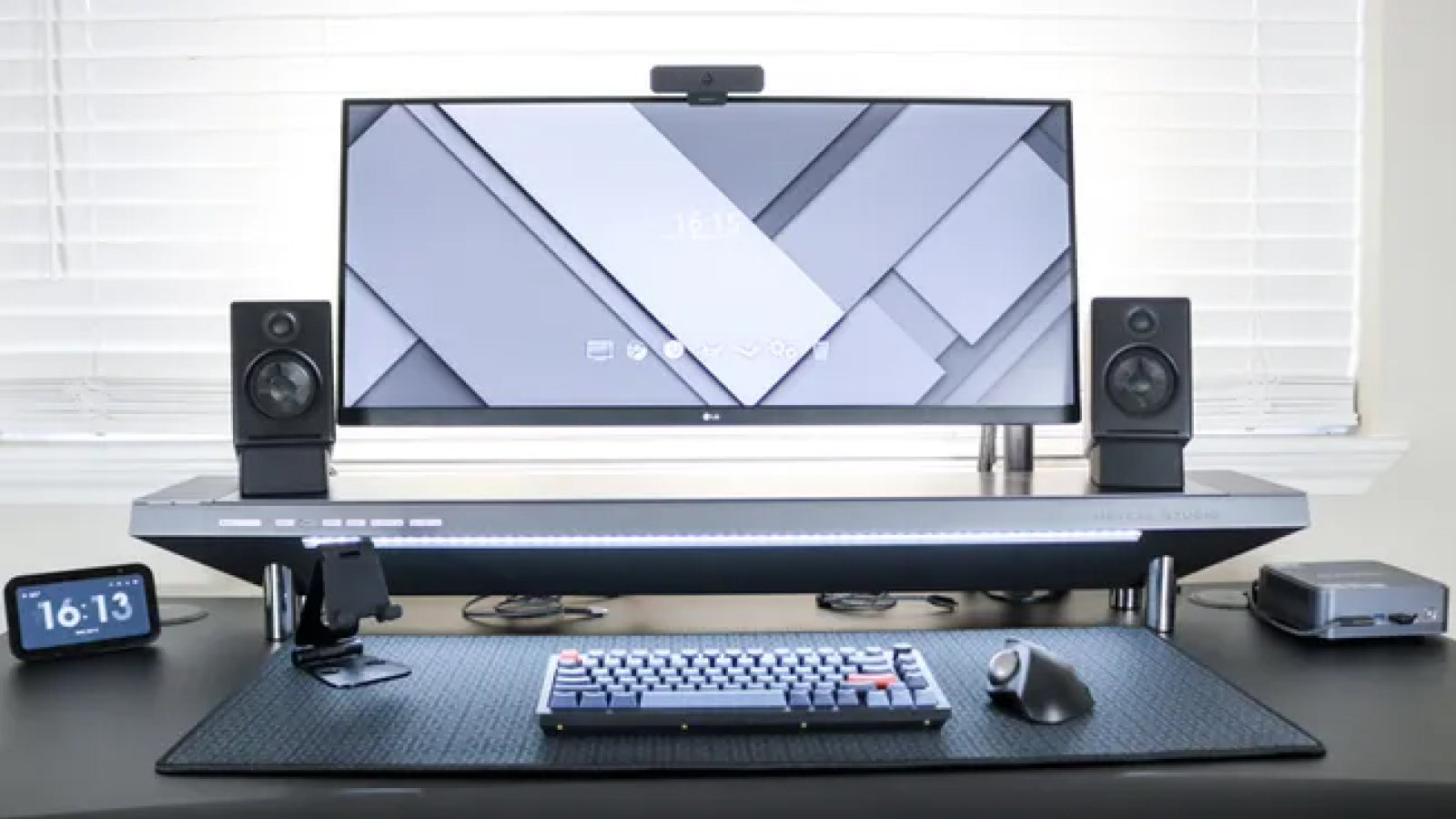 A neatly organized computer desk displaying a monitor and a monitor stand, ideal for productivity.